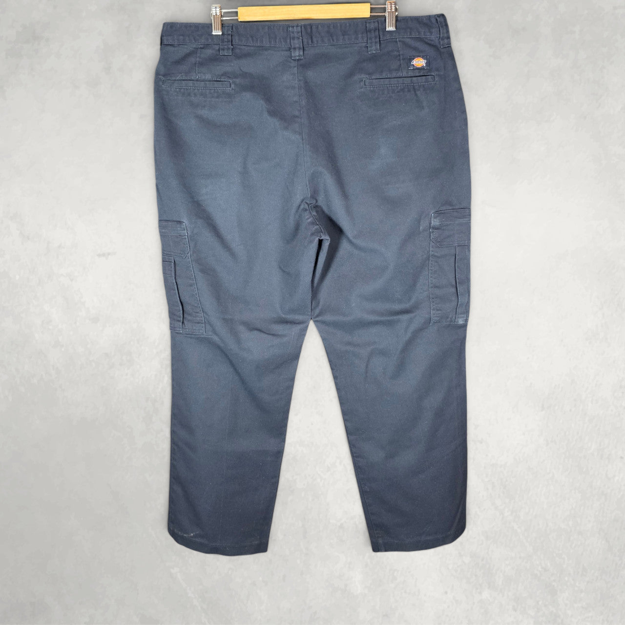 Dickies blue cargo trousers with zipped pockets and relaxed fit, made from durable flex fabric.