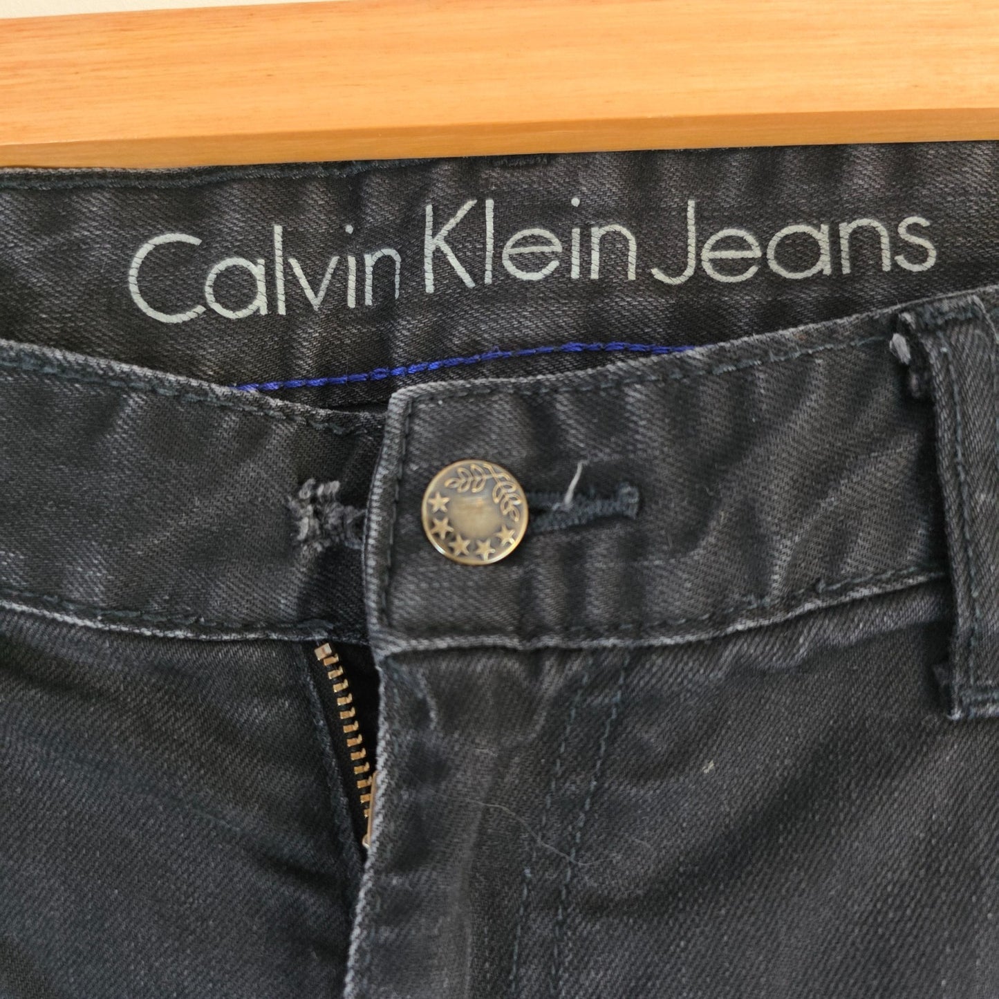 Calvin Klein black straight jeans with logo patch, stretch cotton blend, slim fit design.