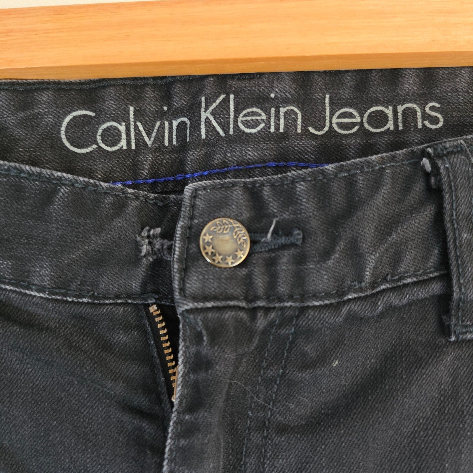Calvin Klein black straight jeans with logo patch, stretch cotton blend, slim fit design.
