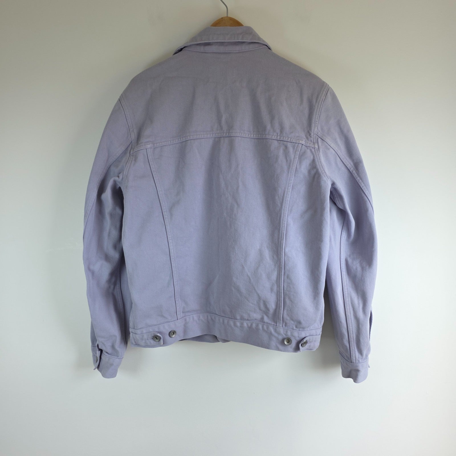 Albam lilac denim jacket with button front, chest pockets, and side pockets.
