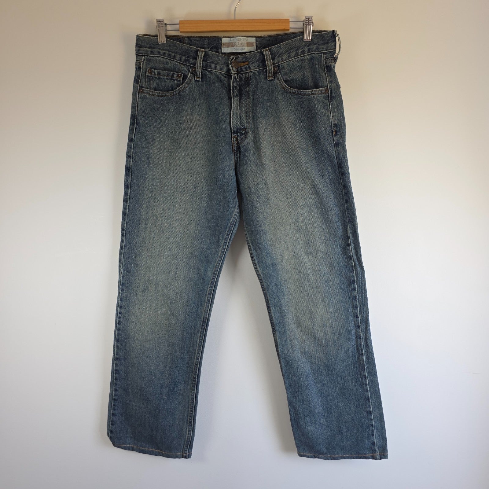 Levi's blue straight leg jeans, cotton material, missing back waist patch, casual style.