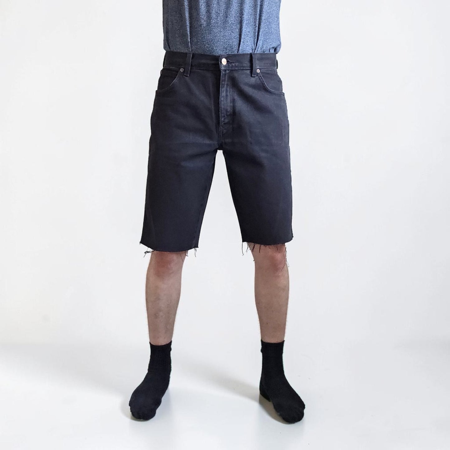 Wrangler black denim shorts W33 with frayed hems and copper-toned button.
