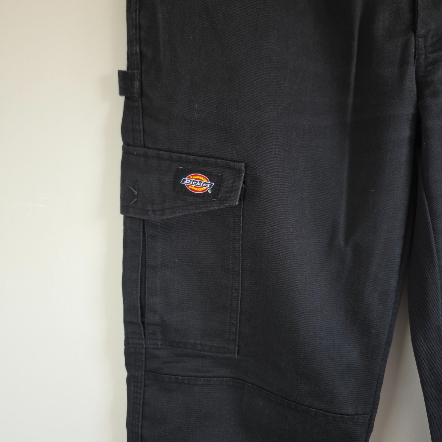 Dickies black cargo trousers with double knee panels and hammer loop detail.