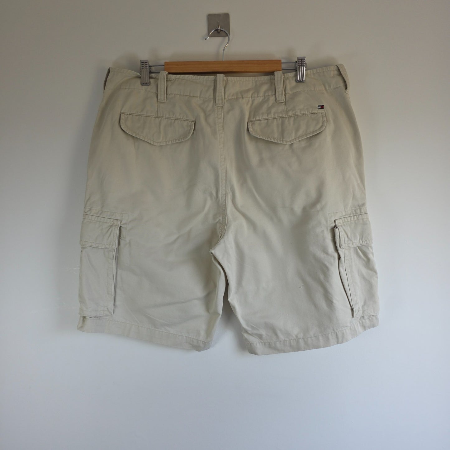 Tommy Hilfiger beige cargo shorts with utility pockets and cotton material.