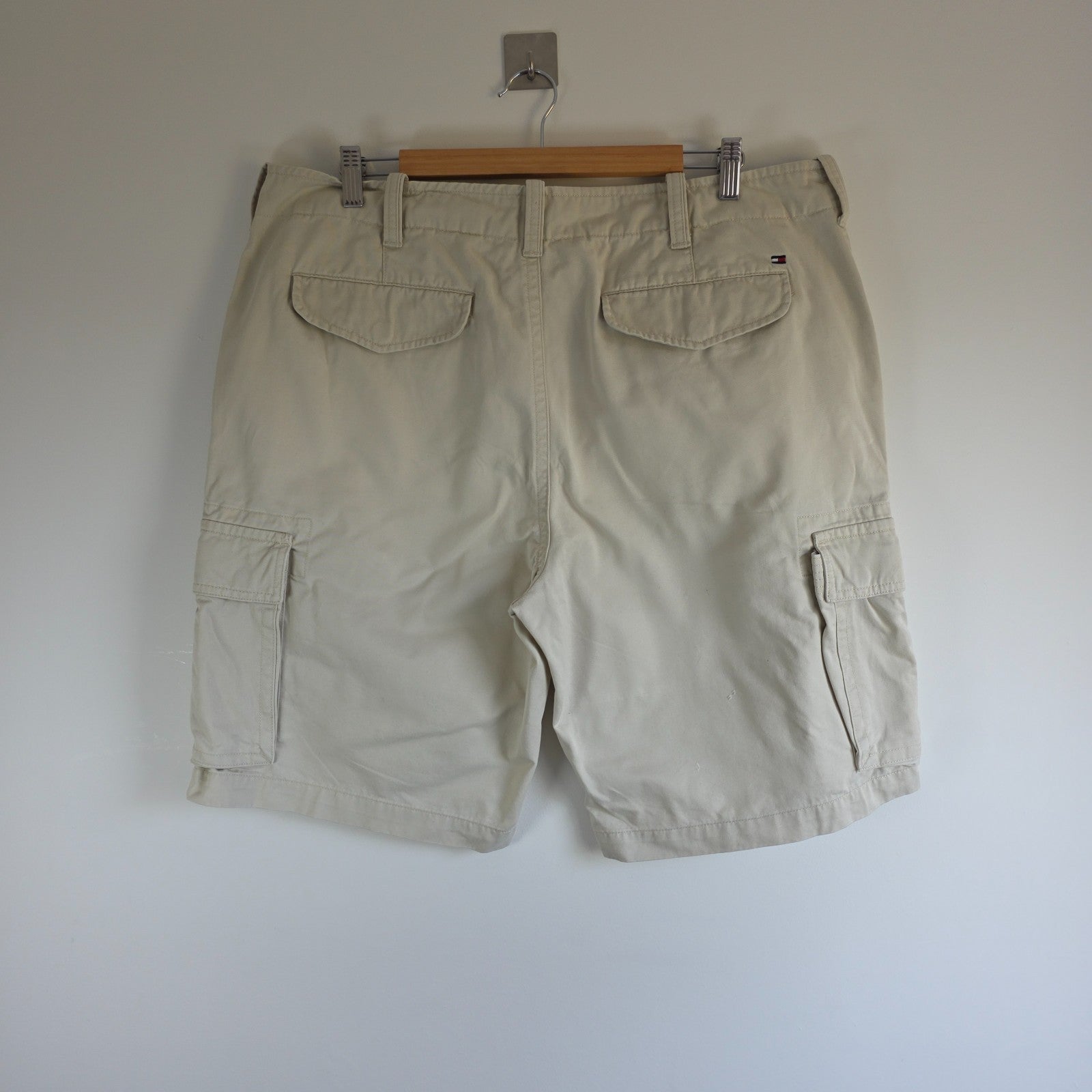 Tommy Hilfiger beige cargo shorts with utility pockets and cotton material.