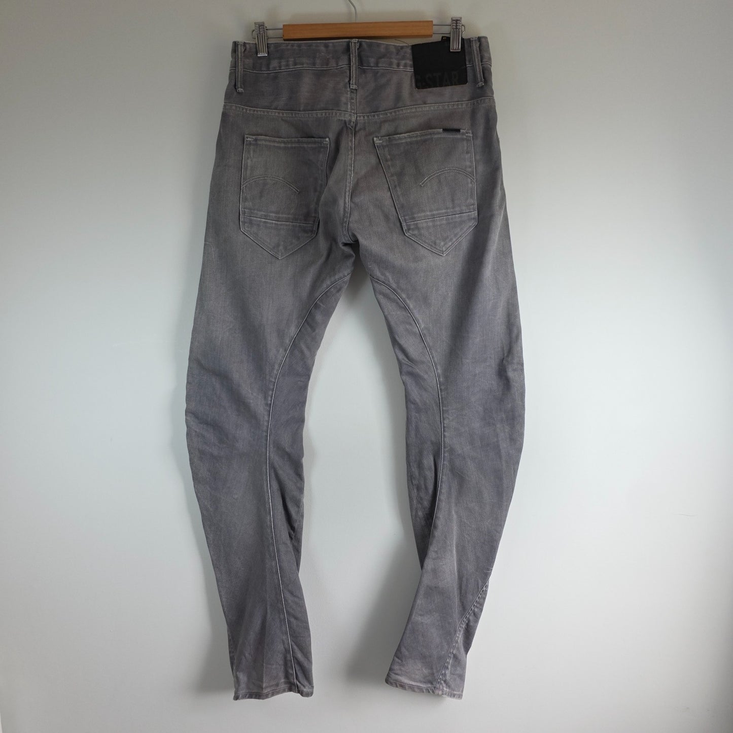 G-Star grey straight jeans with biker style detailing and subtle wear at the hem.