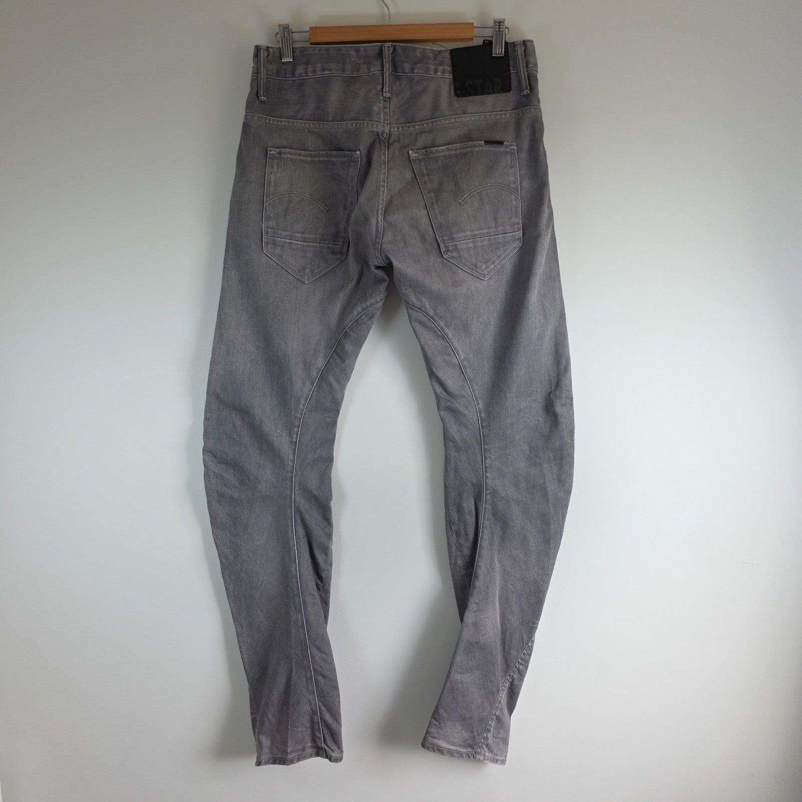 G-Star grey straight jeans with biker style detailing and subtle wear at the hem.