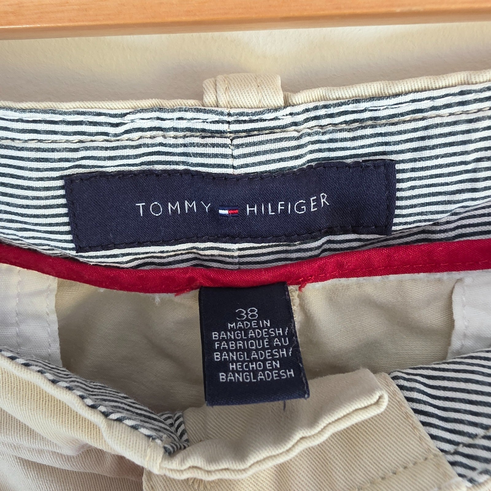 Tommy Hilfiger beige cargo shorts with utility pockets and cotton material.