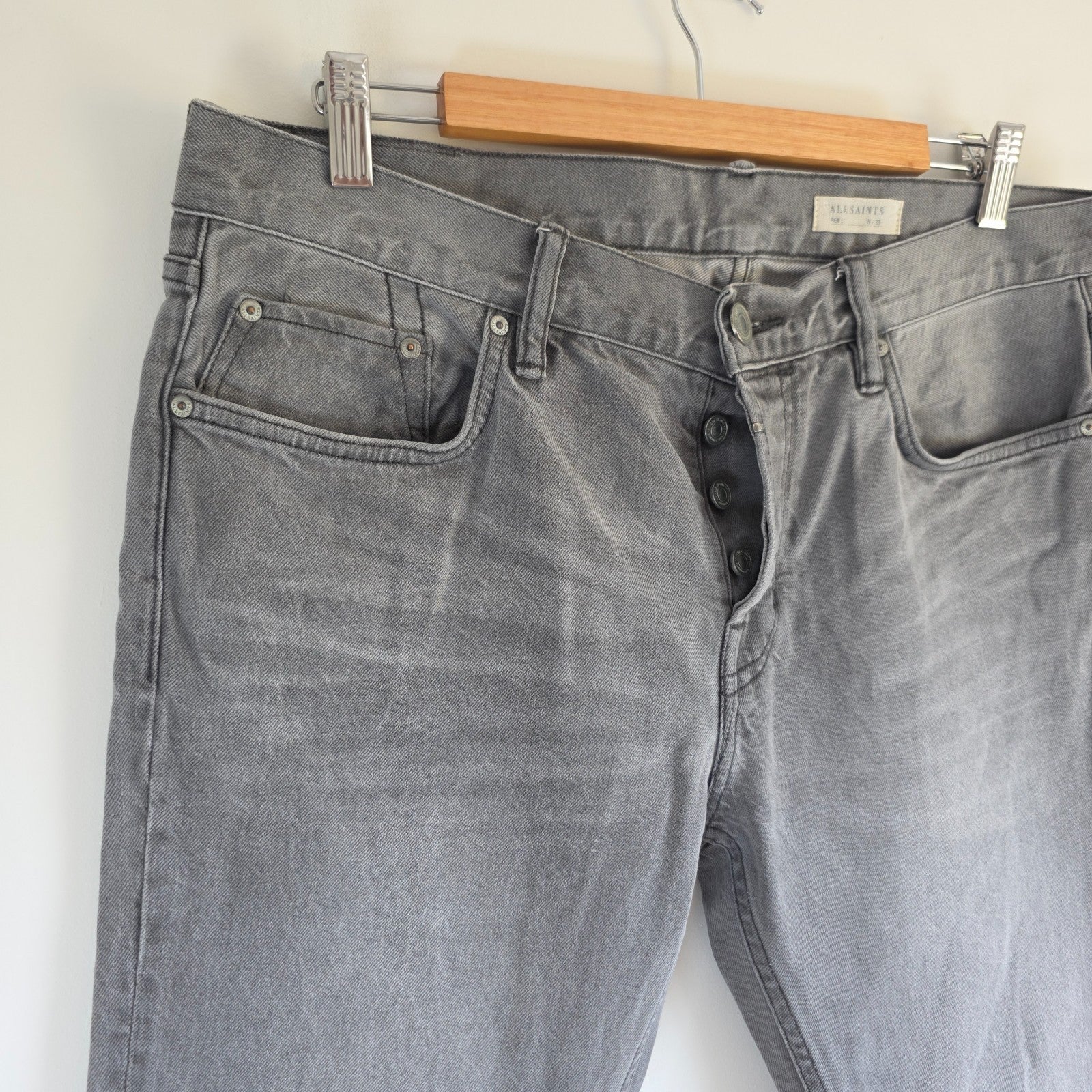 AllSaints grey slim jeans with button fly and stretch cotton elastane blend.