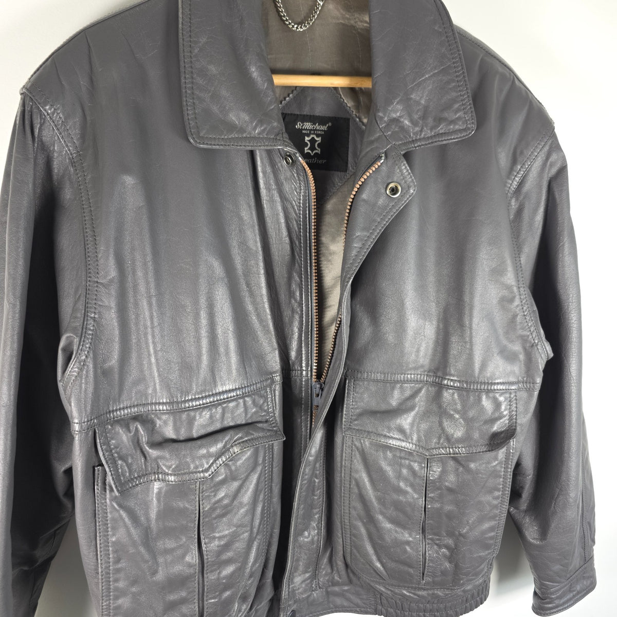 St Michael grey leather bomber jacket with utility pockets and elasticated waistband.