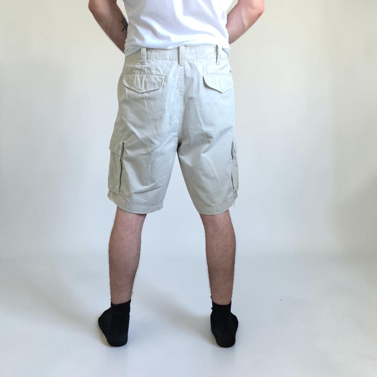 Tommy Hilfiger beige cargo shorts with utility pockets and cotton material.