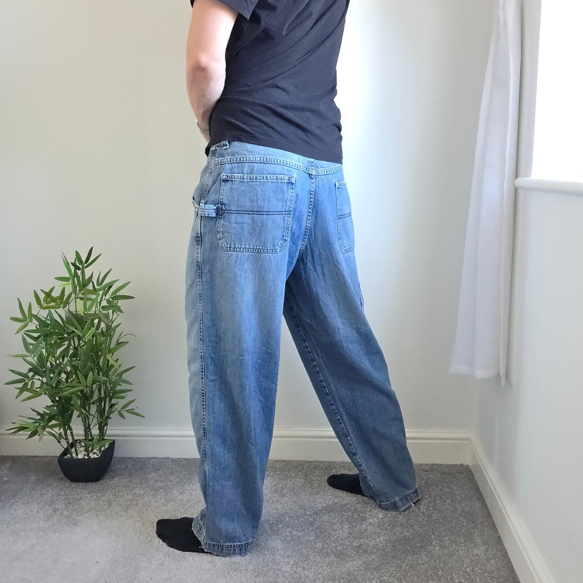 Old Navy blue carpenter jeans with hammer loop and utility pocket detailing.