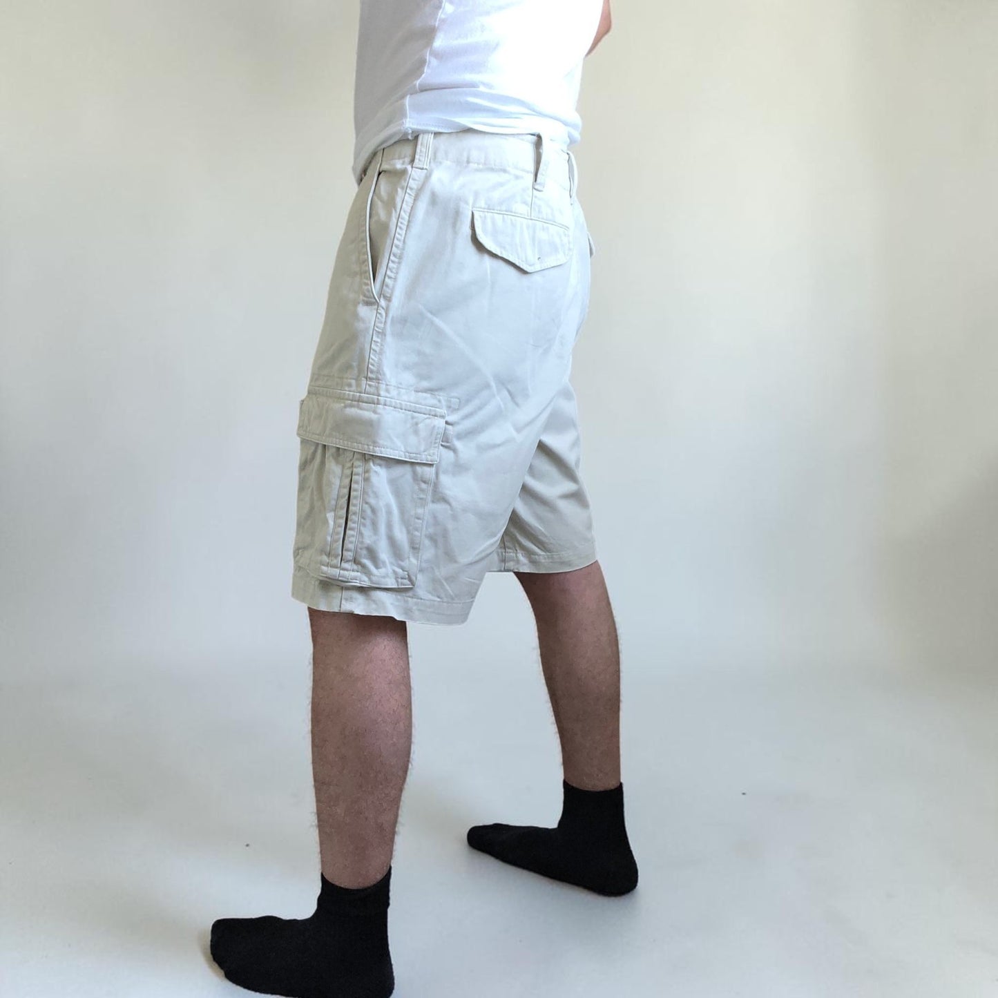 Tommy Hilfiger beige cargo shorts with utility pockets and cotton material.