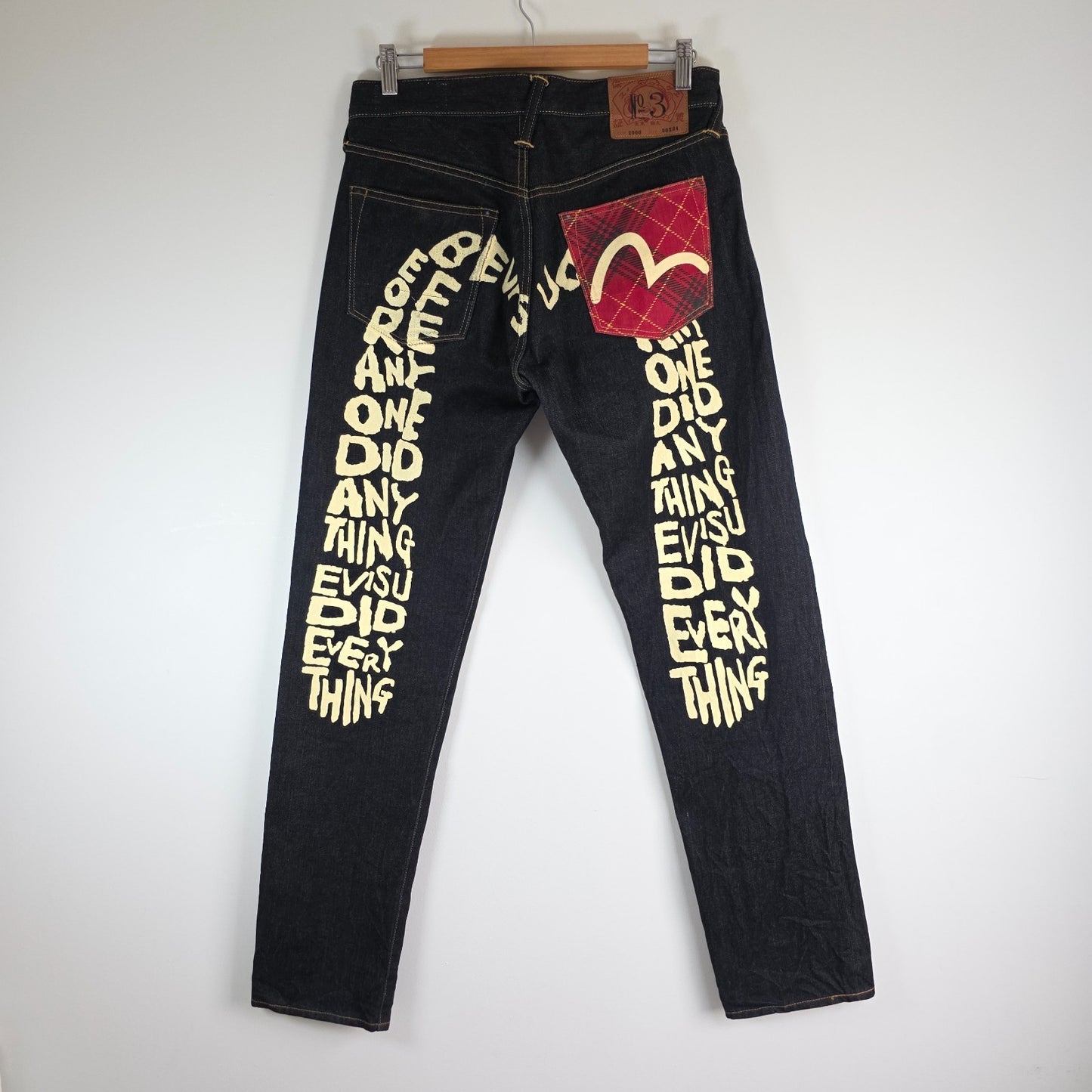 Evisu blue straight jeans with selvedge denim and button fly detailing.