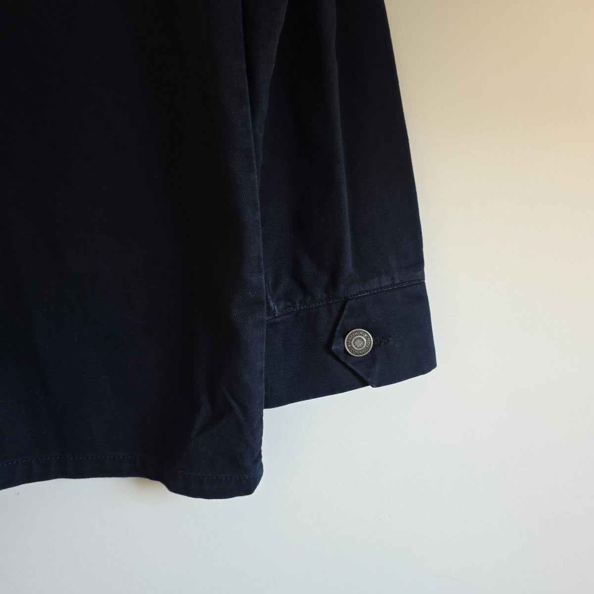 French Connection blue chore jacket with three patch pockets and metal button fastening.