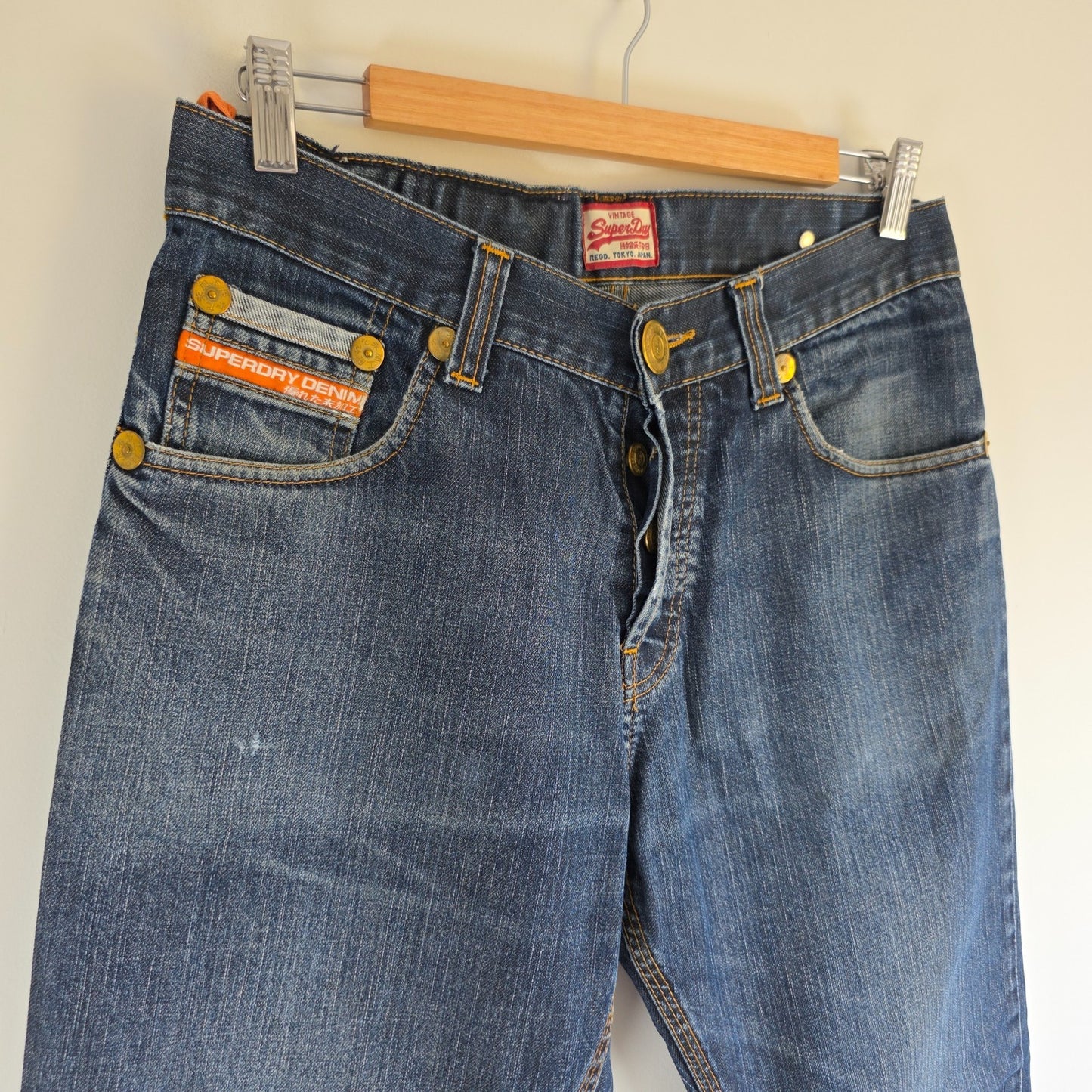 Superdry blue straight jeans with button fly, vintage raw denim, light wear.