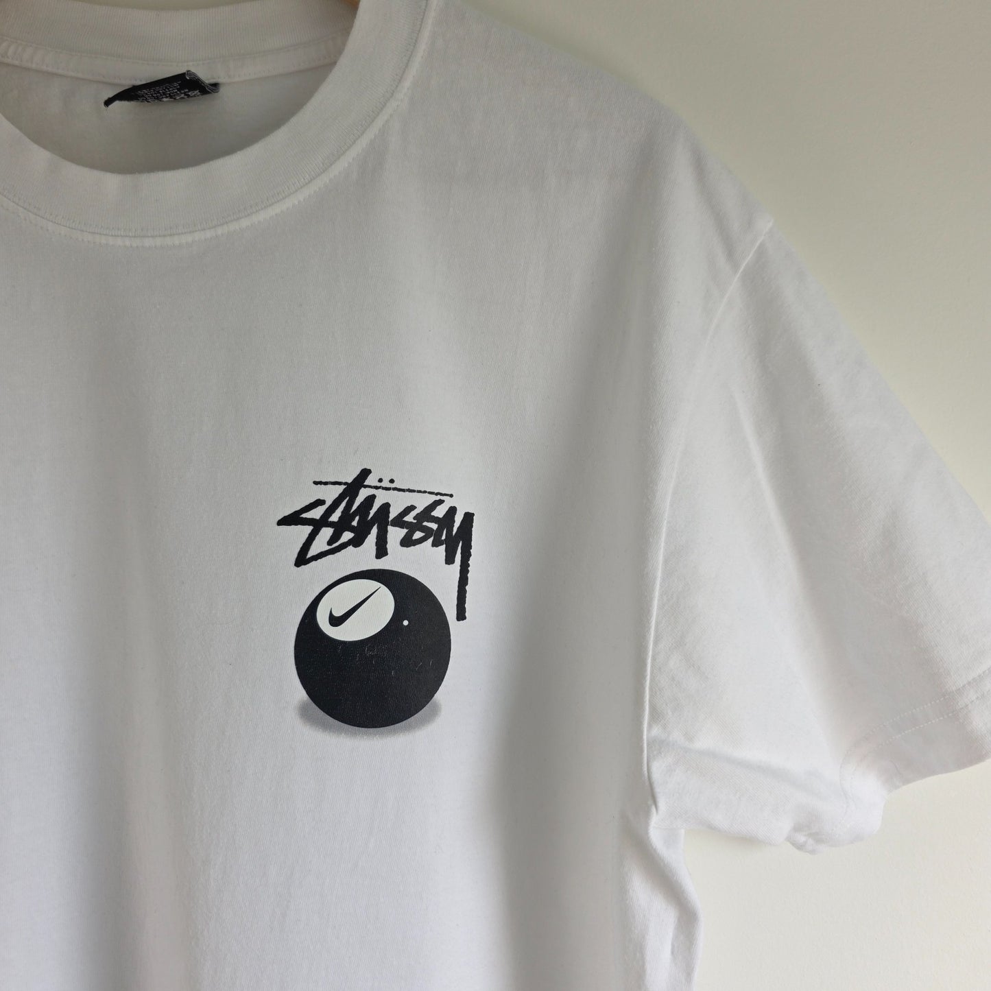 Stüssy x Nike white t-shirt with large 8 Ball back print and cotton material.