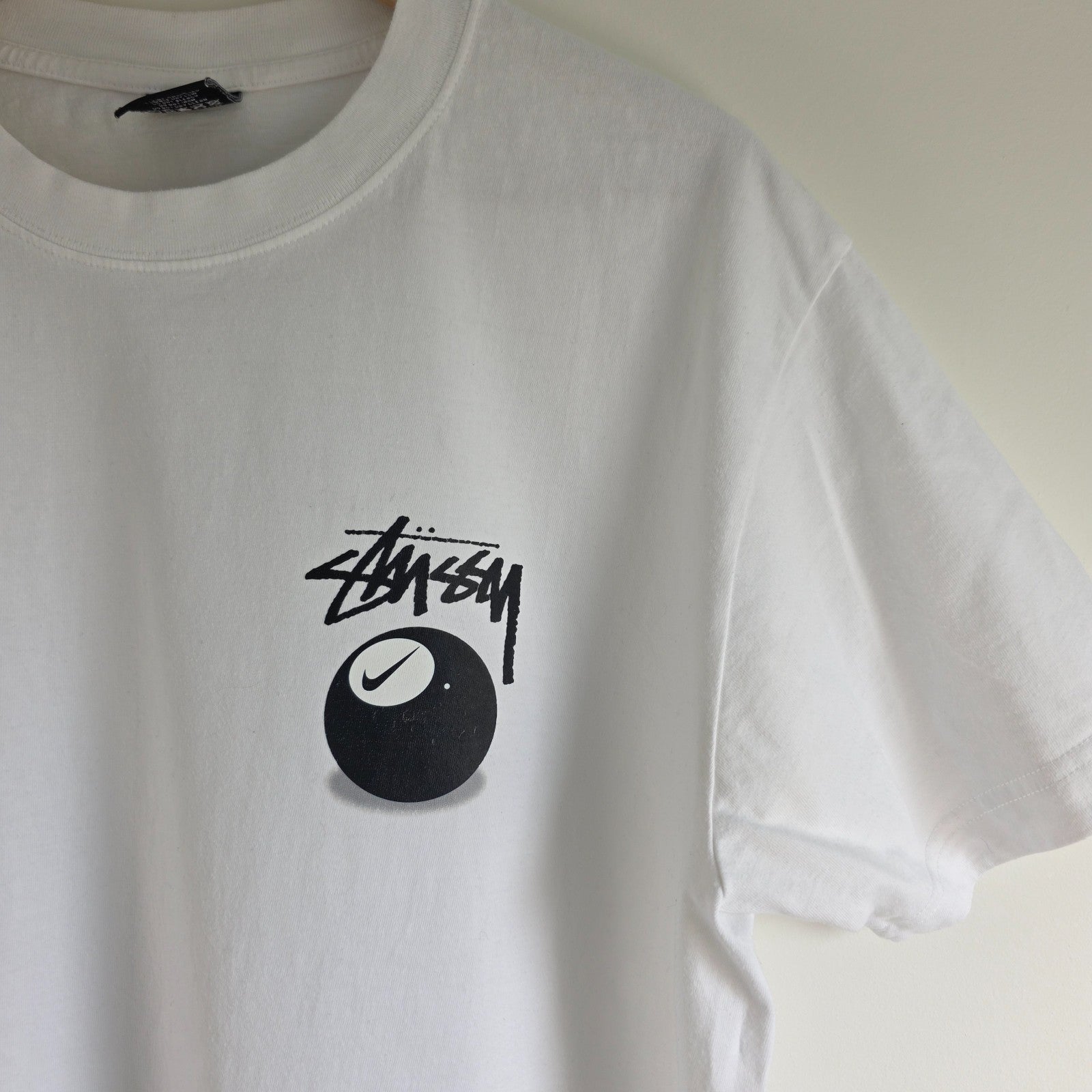 Stüssy x Nike white t-shirt with large 8 Ball back print and cotton material.