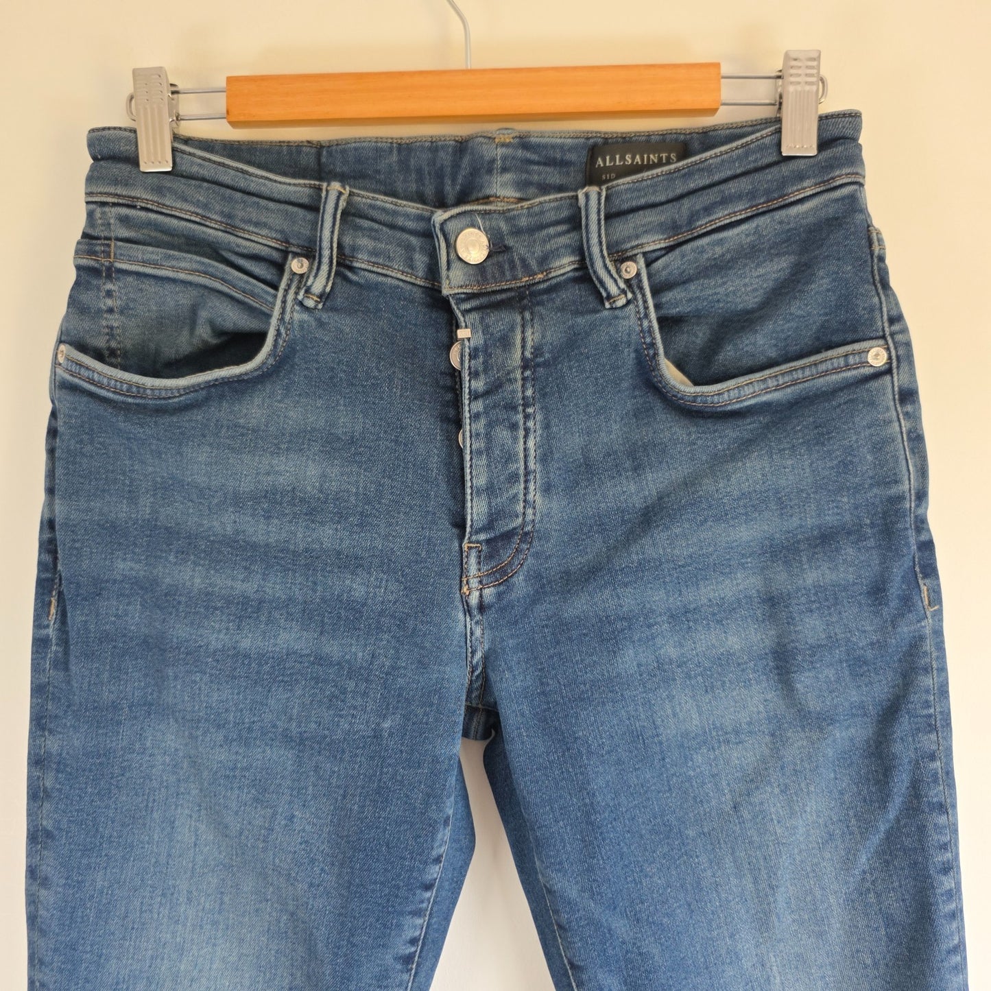 AllSaints blue straight jeans with button fly and stretch cotton-elastane blend.