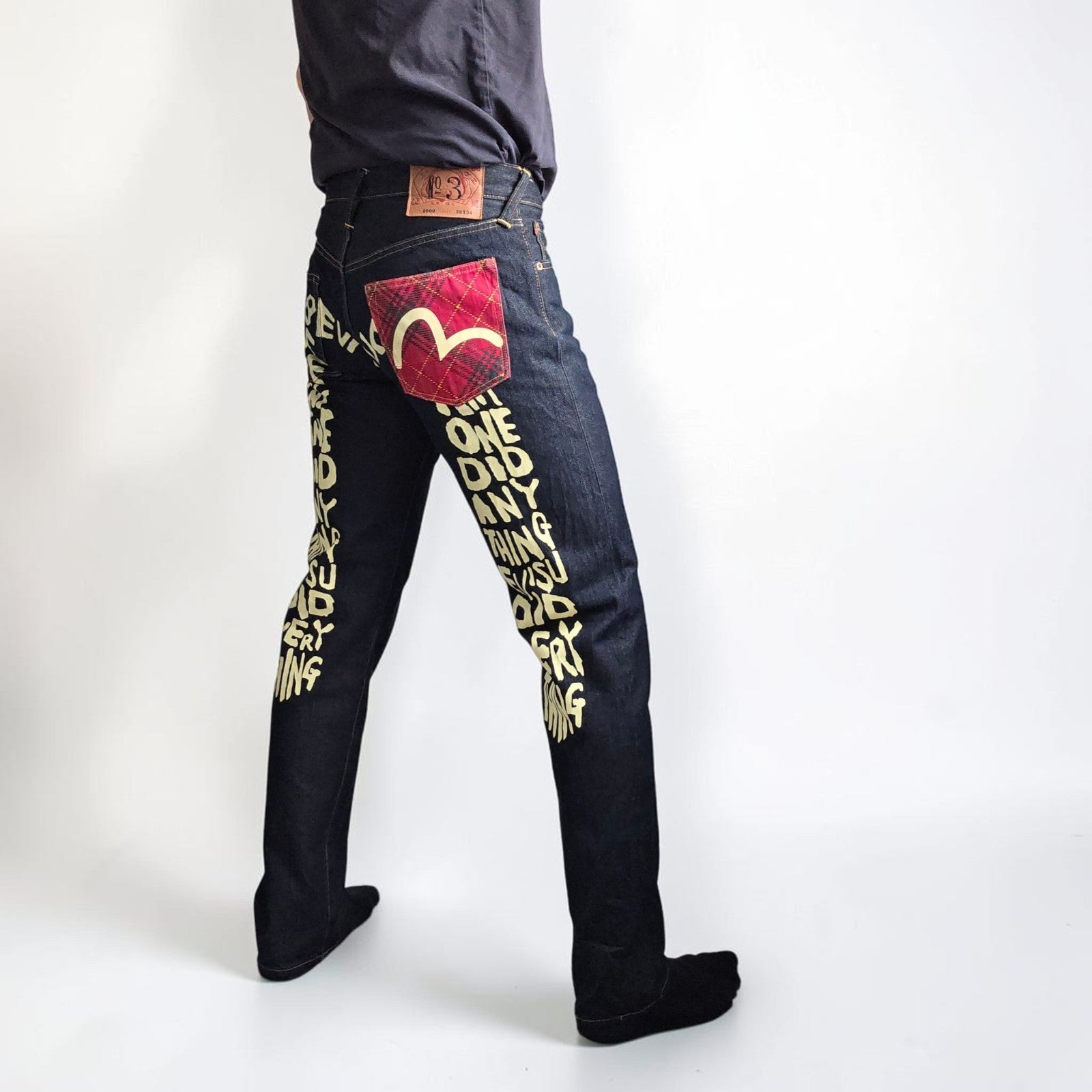 Evisu blue straight jeans with selvedge denim and button fly detailing.