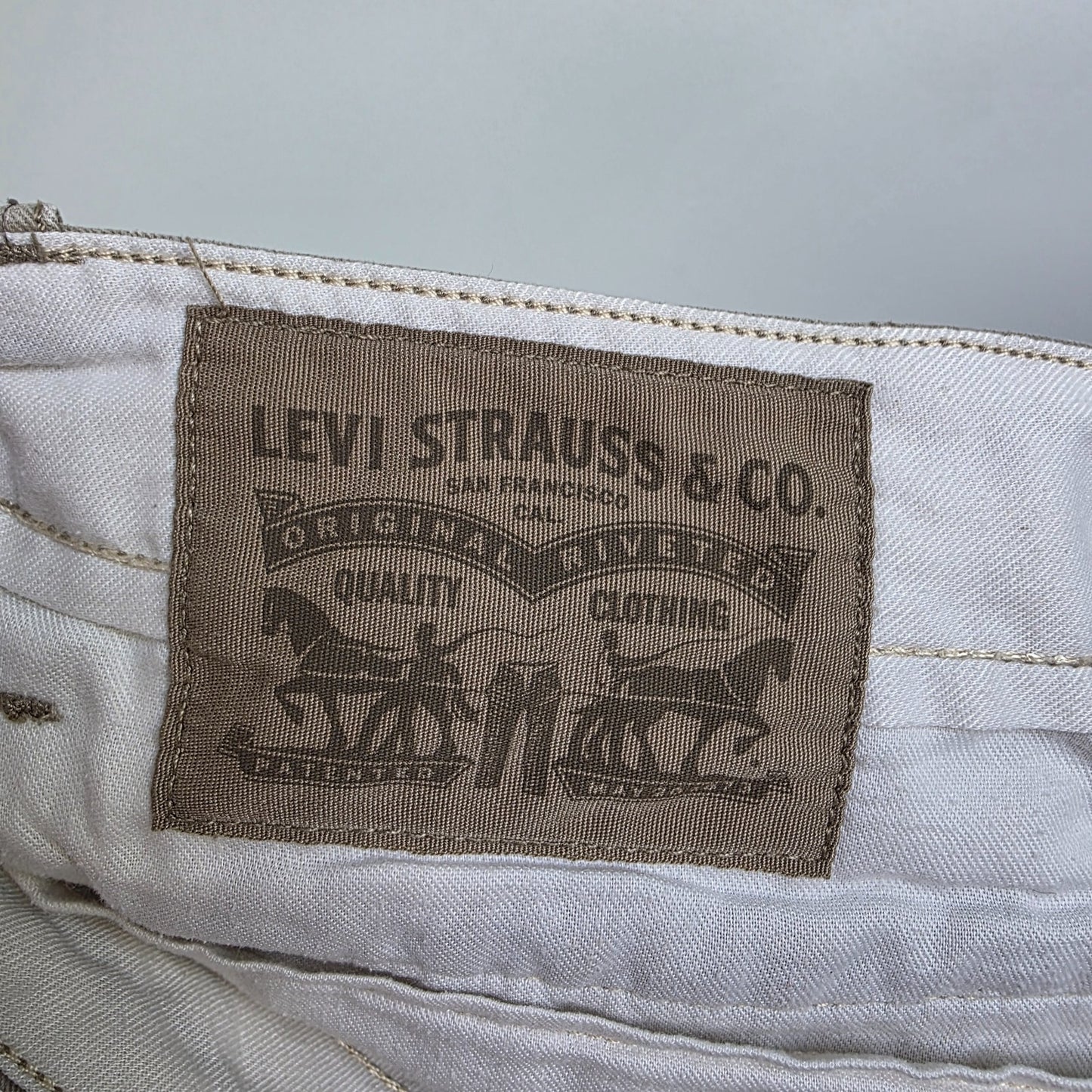 Levi's beige cargo shorts with utility pockets and cotton material, very good condition.