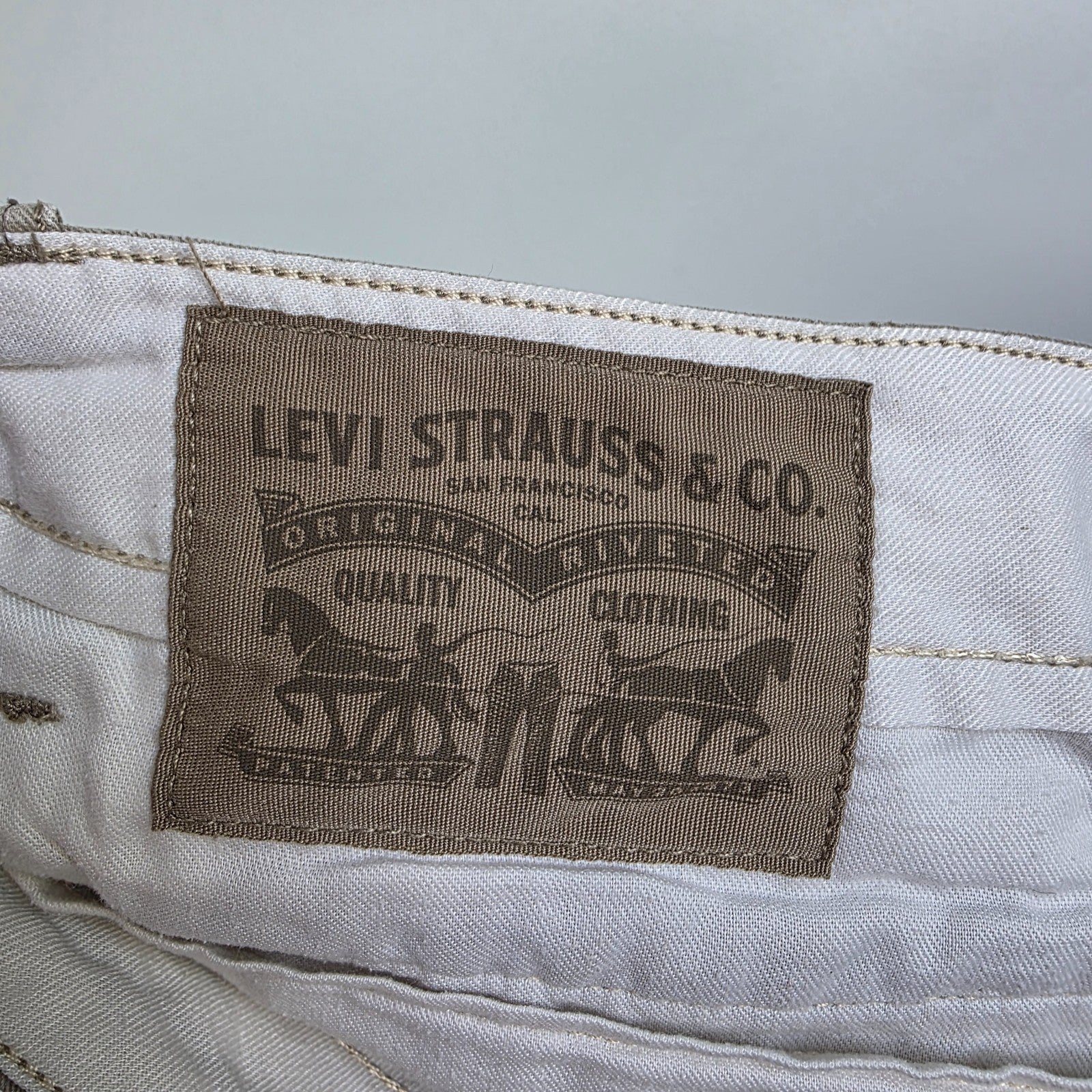 Levi's beige cargo shorts with utility pockets and cotton material, very good condition.