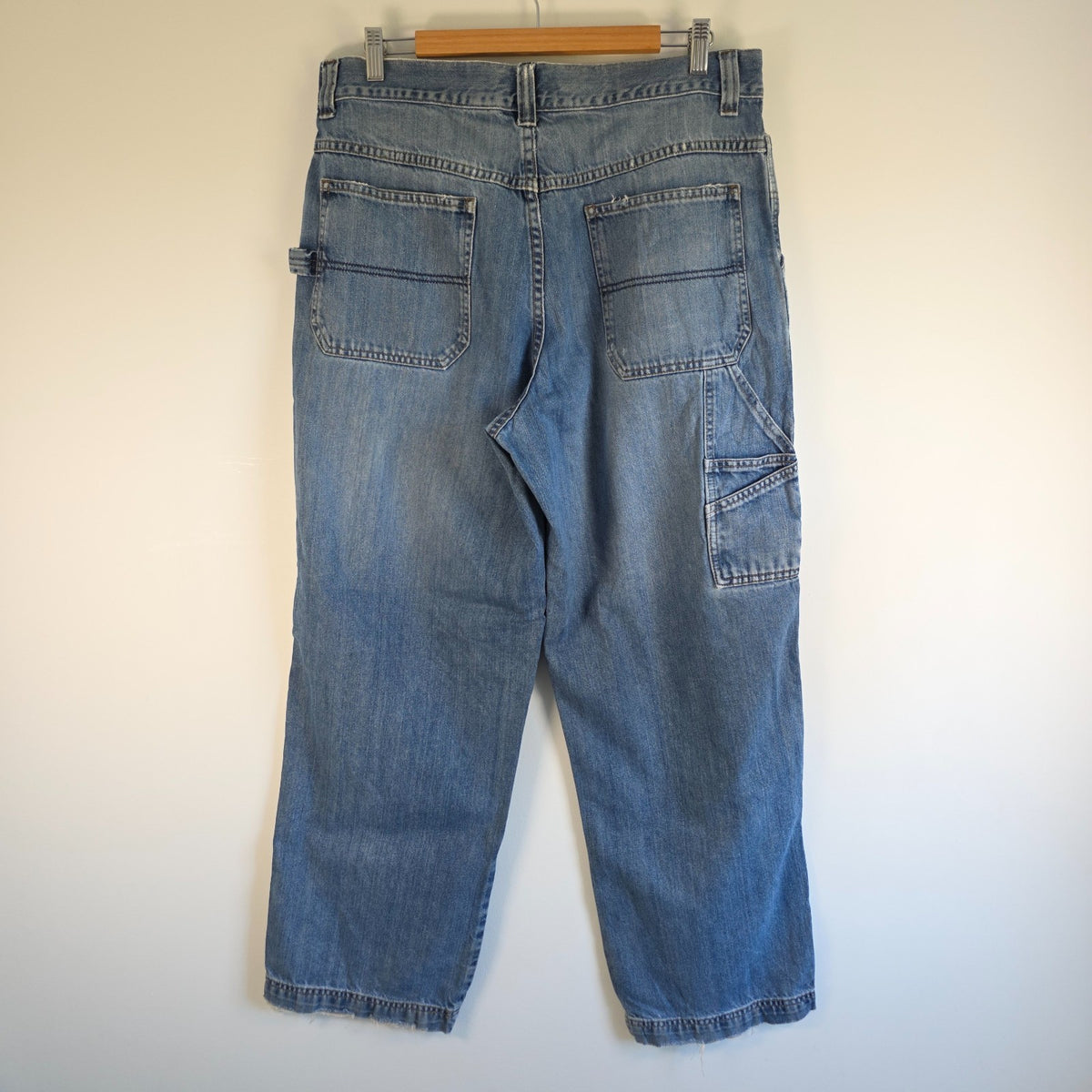Old Navy blue carpenter jeans with hammer loop and utility pocket detailing.