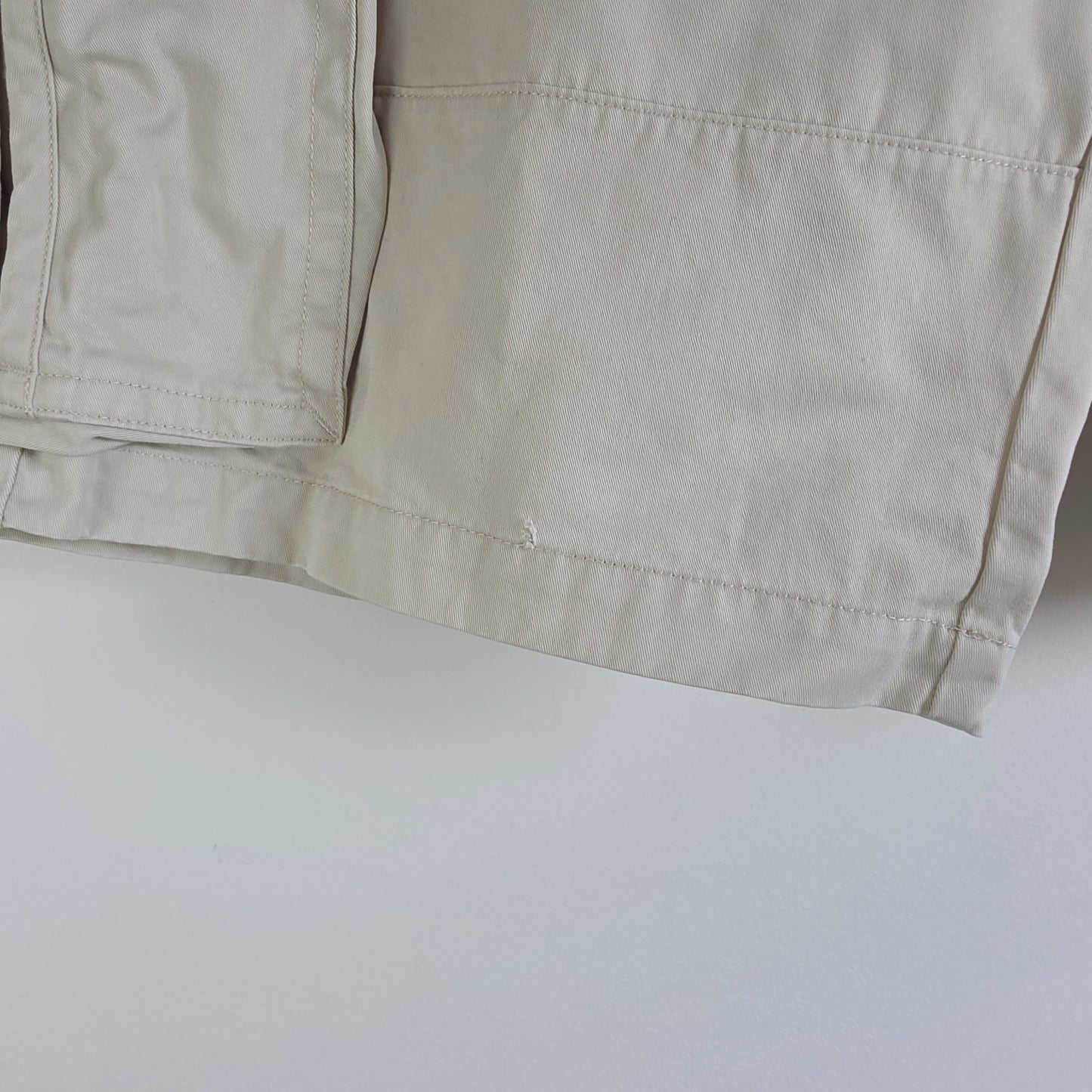 Tommy Hilfiger beige cargo shorts with utility pockets and cotton material.