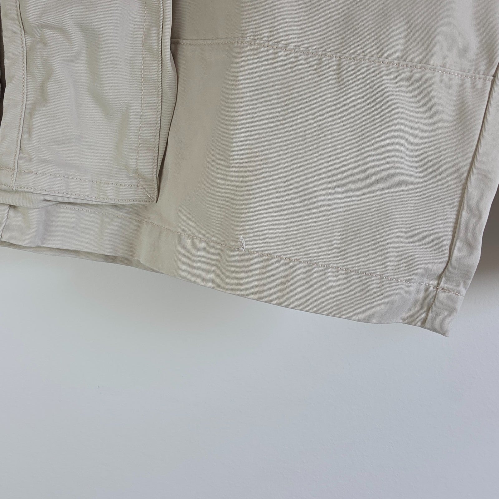 Tommy Hilfiger beige cargo shorts with utility pockets and cotton material.