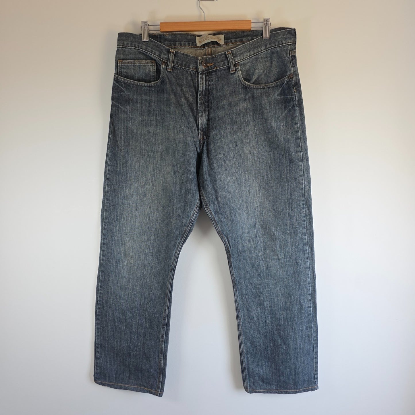 Wrangler blue straight jeans with relaxed fit, 100% cotton, professional hemmed to 30 inches.