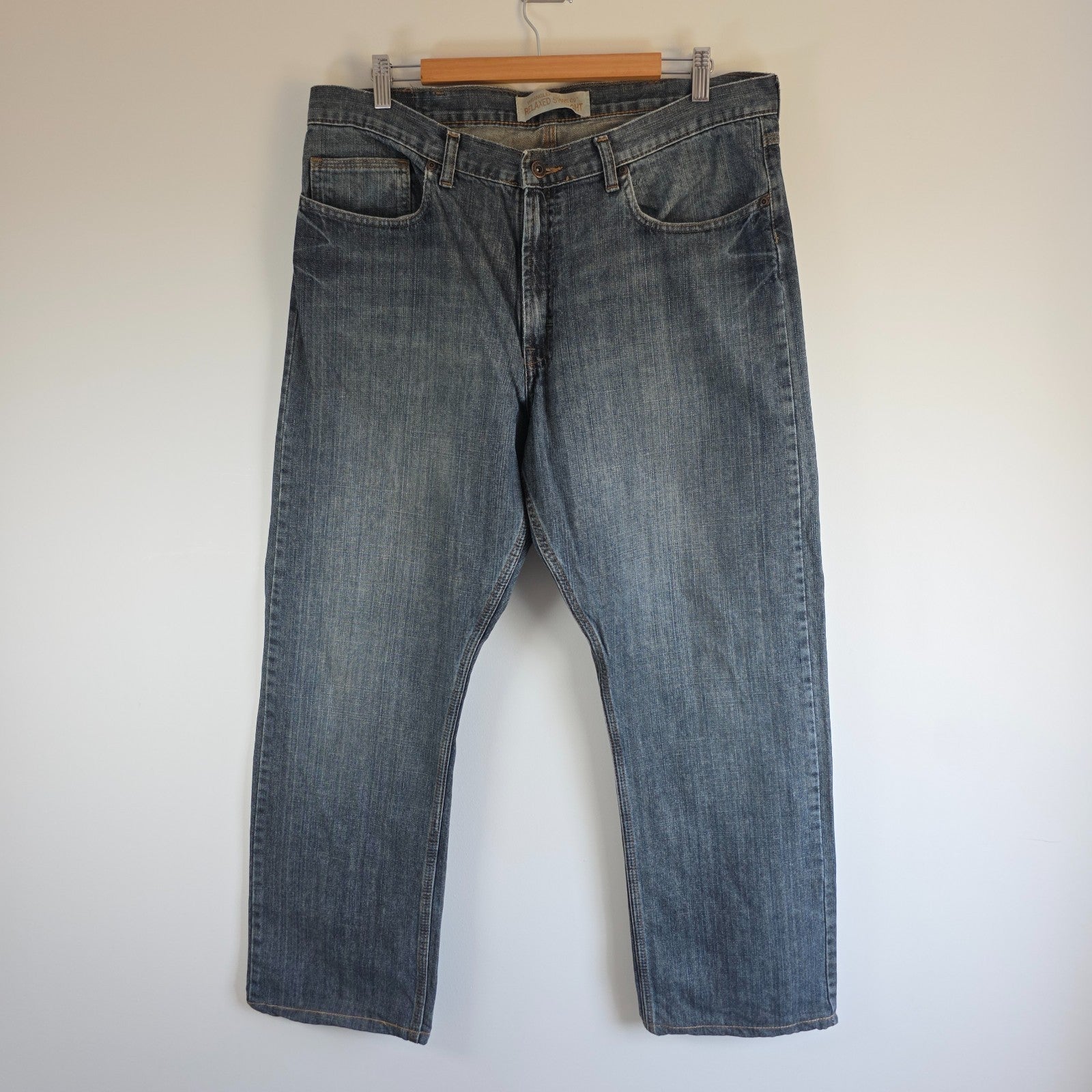 Wrangler blue straight jeans with relaxed fit, 100% cotton, professional hemmed to 30 inches.