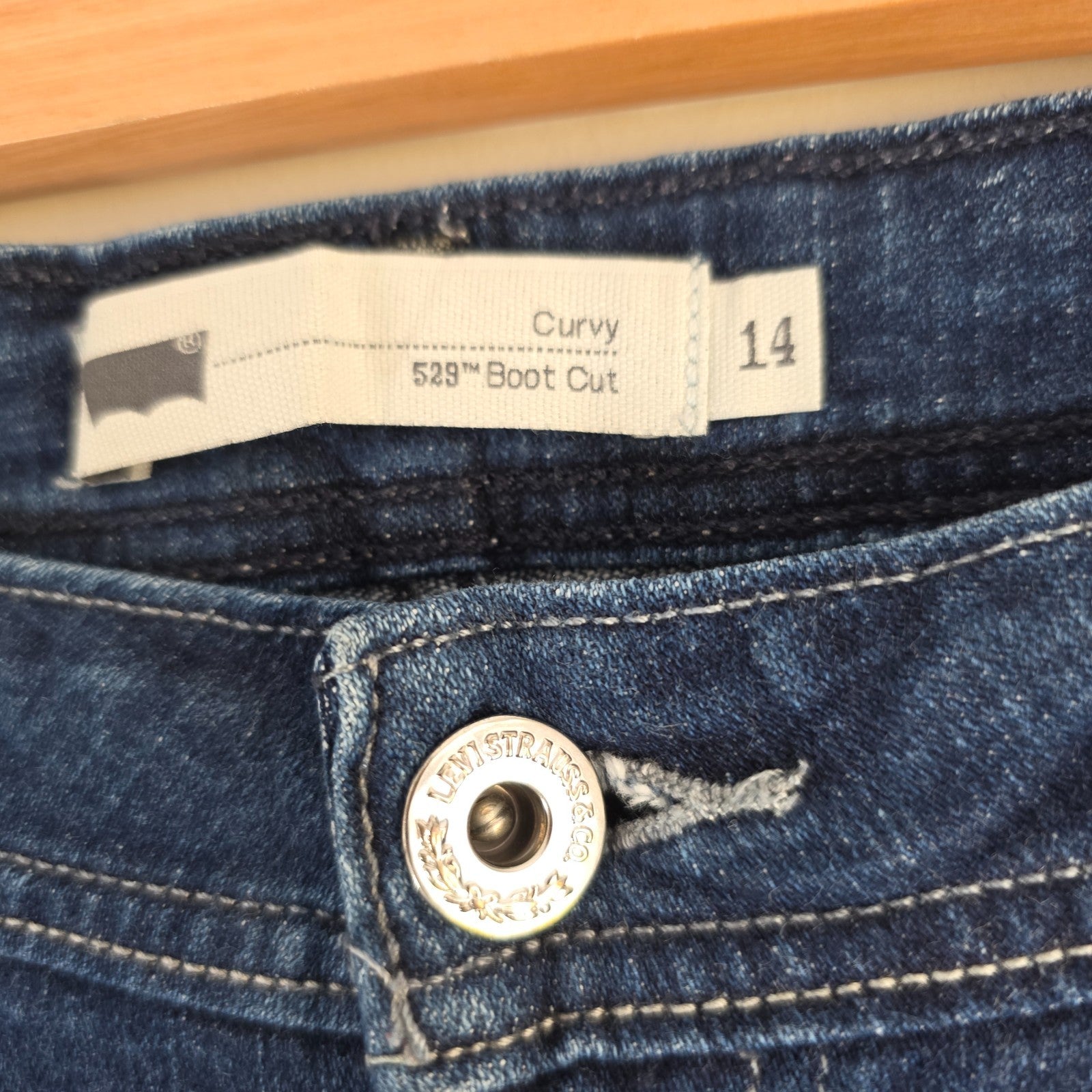 Levi's blue straight jeans with distressed details and classic 501 logo.