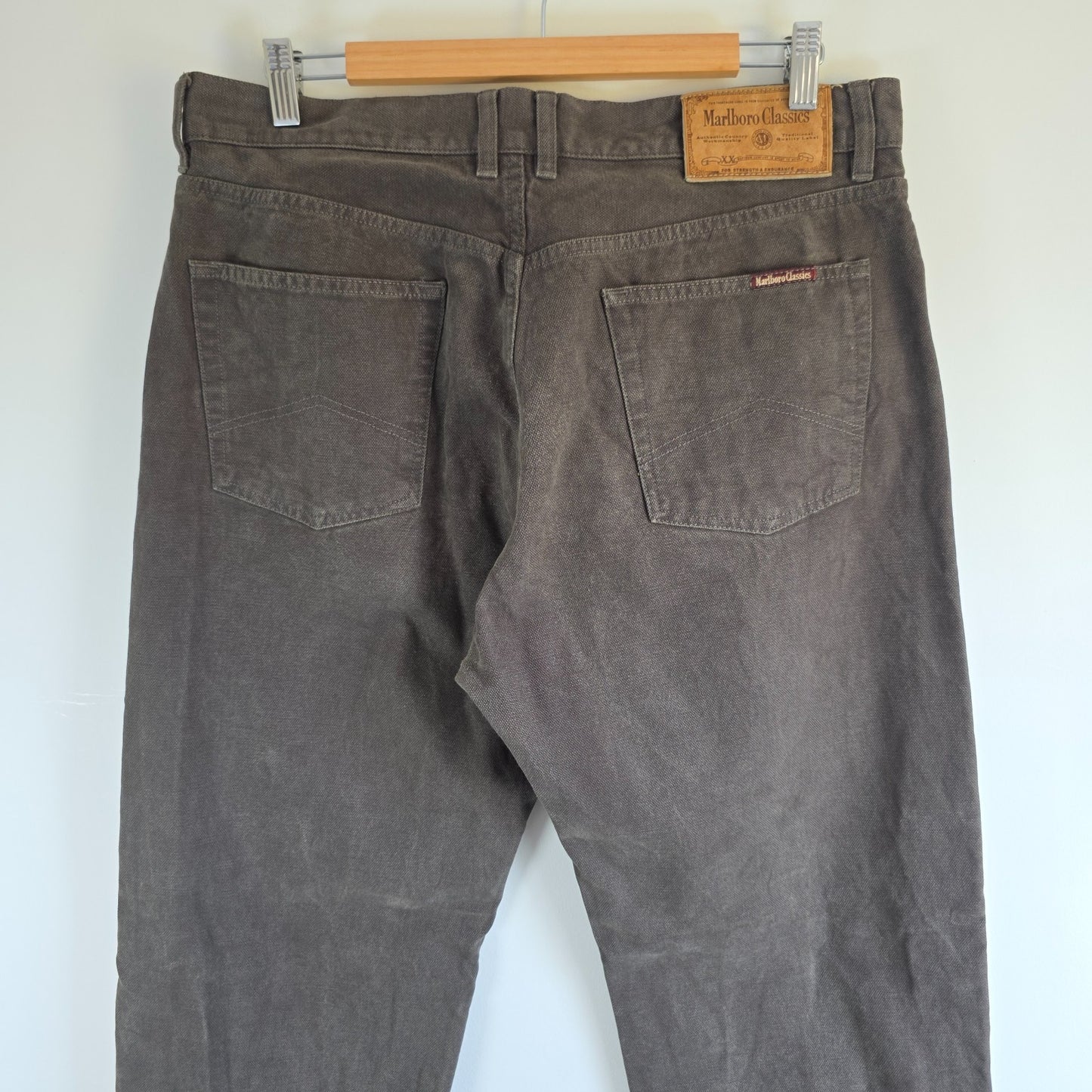 Marlboro Classics grey straight jeans with button fly and vintage logo detail.