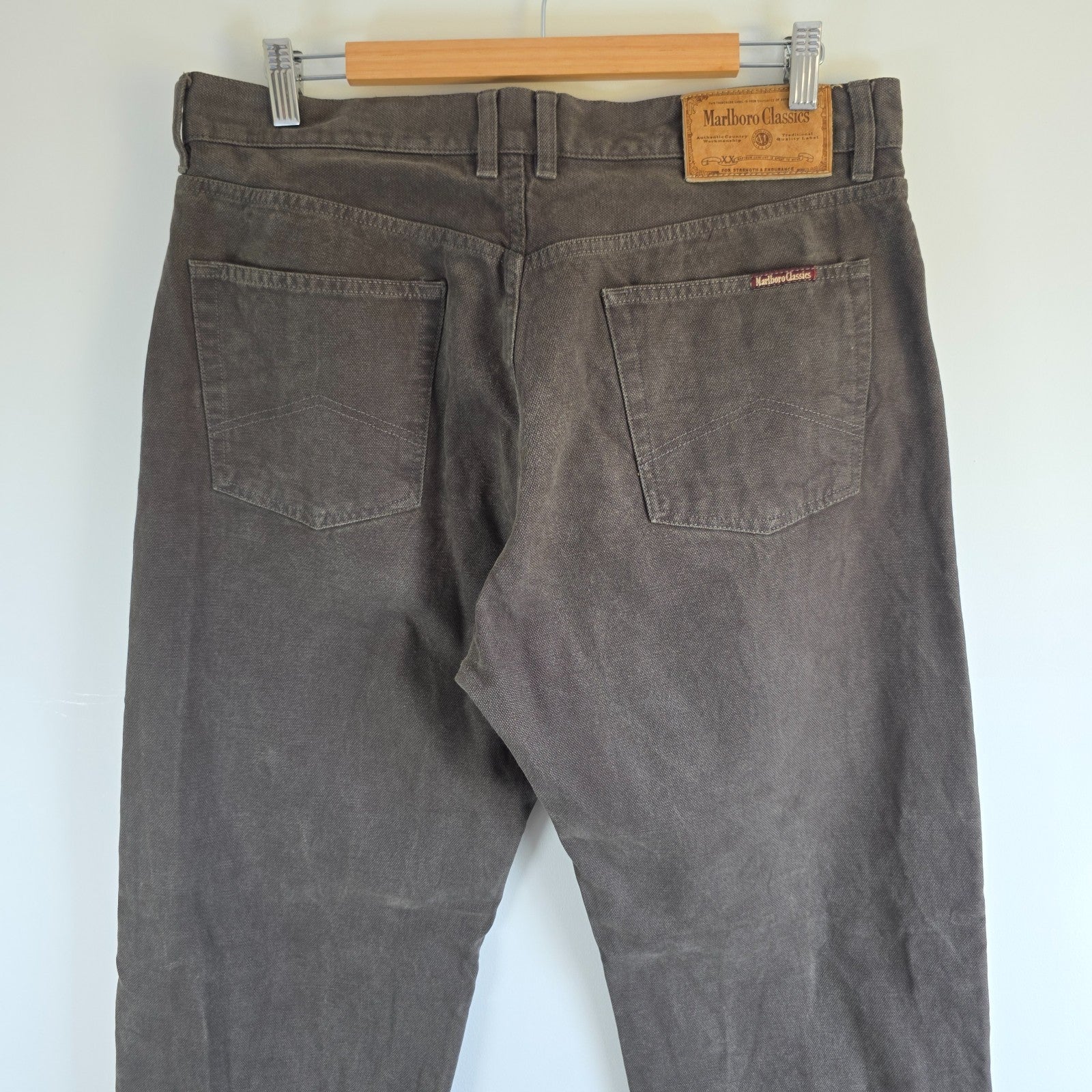 Marlboro Classics grey straight jeans with button fly and vintage logo detail.