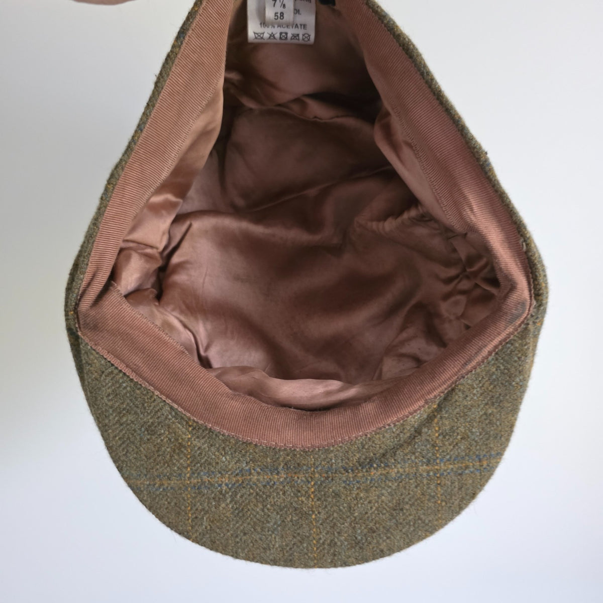 William Powell brown tweed flat cap with stitched panel construction and subtle flecks.