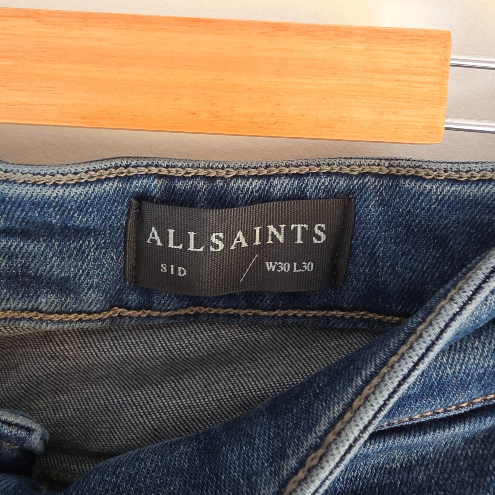 AllSaints blue straight jeans with button fly and stretch cotton-elastane blend.