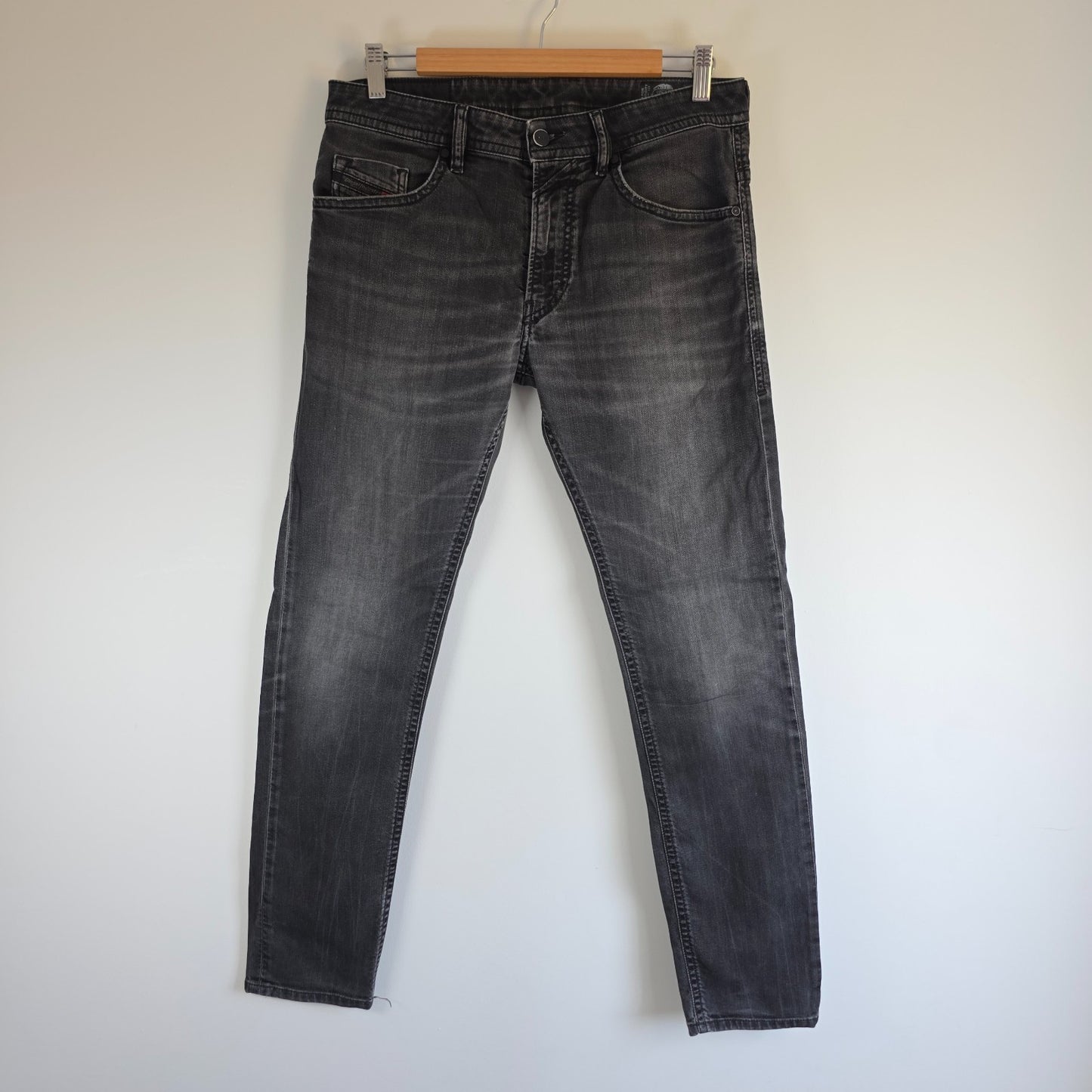 Diesel black straight jeans with grey wash, stretch denim, and branded tag.