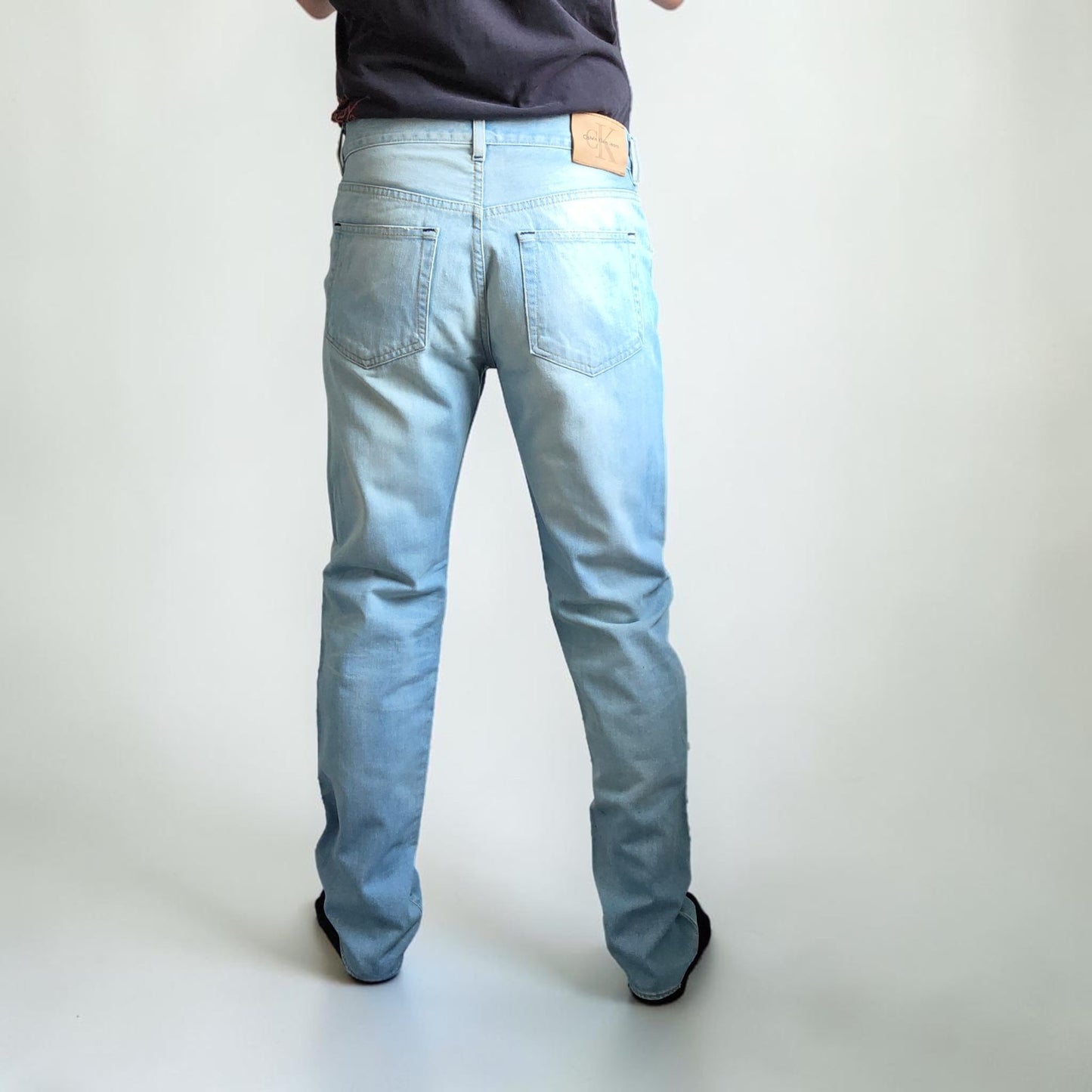 Calvin Klein light blue straight jeans, 100% cotton, classic five-pocket design.