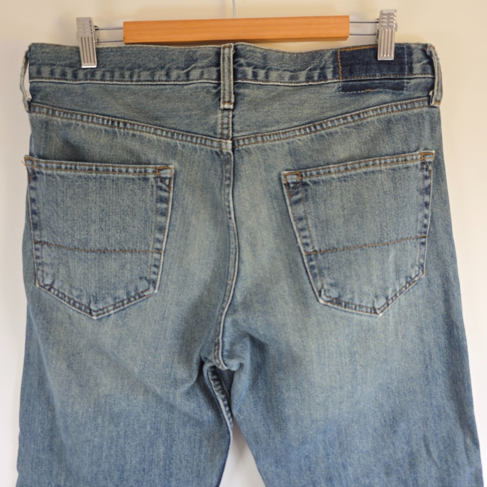 Levi's blue straight leg jeans, cotton material, missing back waist patch, casual style.