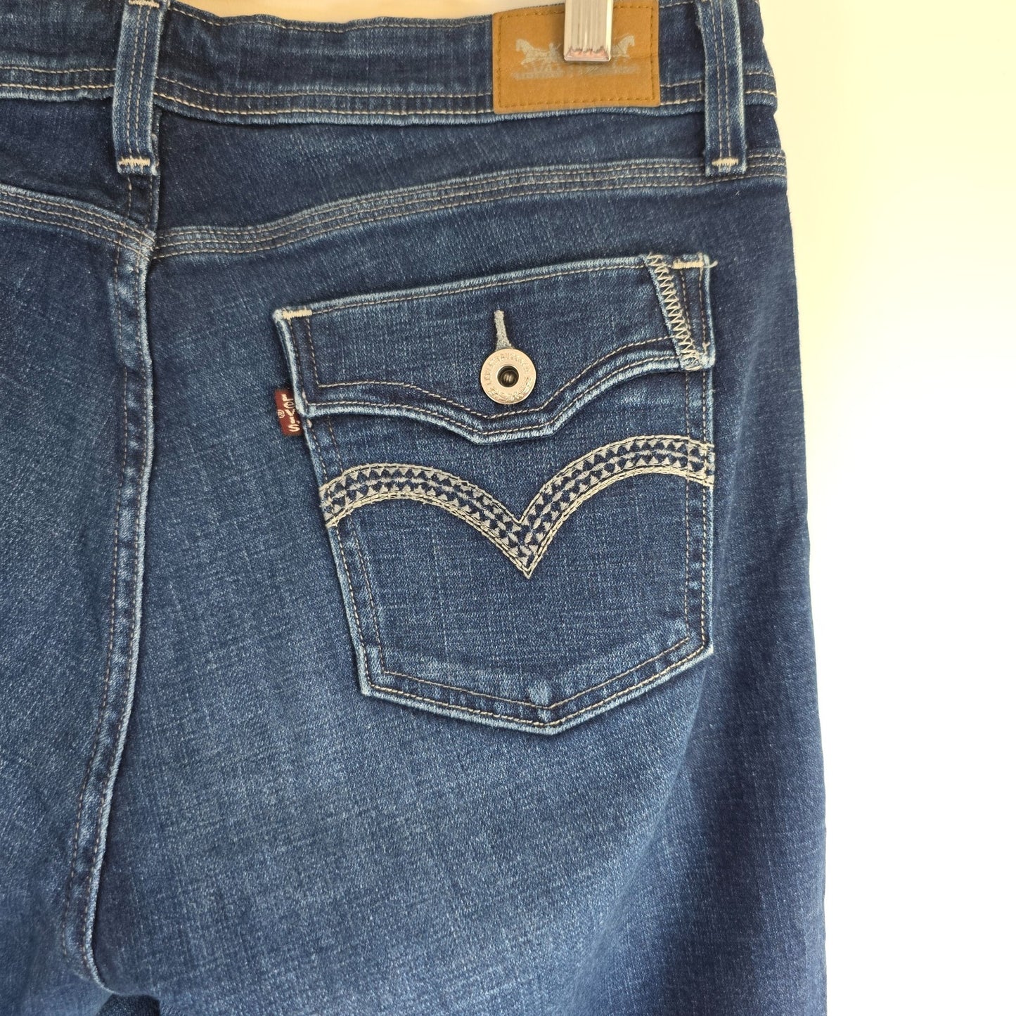 Levi's blue straight jeans with distressed details and classic 501 logo.