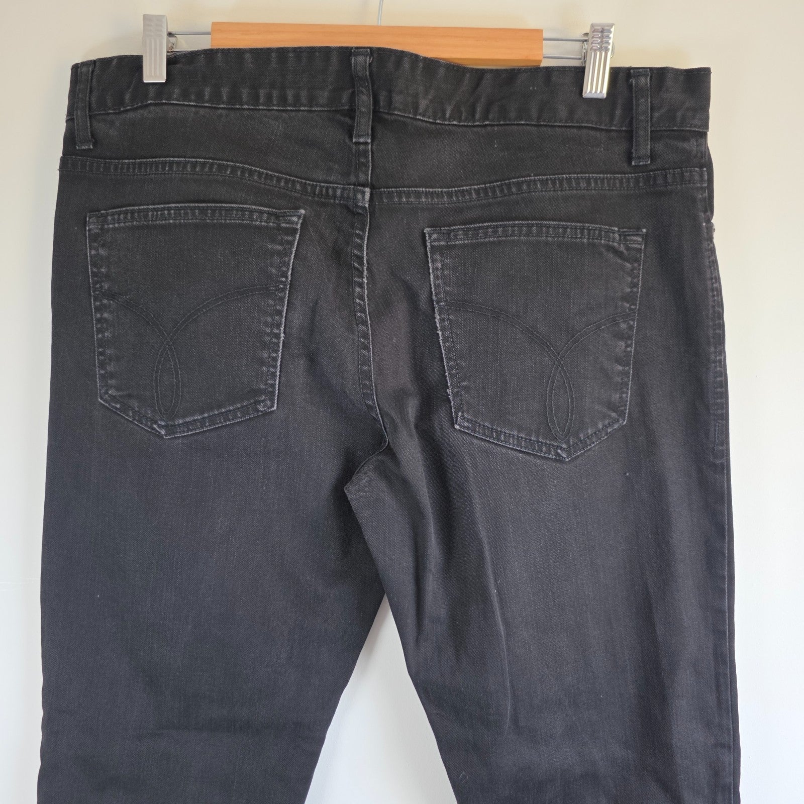 Calvin Klein black straight jeans with logo patch, stretch cotton blend, slim fit design.