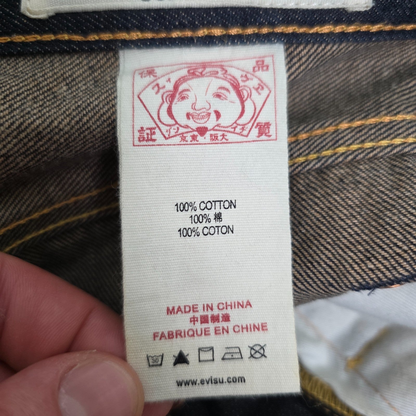 Evisu blue straight jeans with selvedge denim and button fly detailing.
