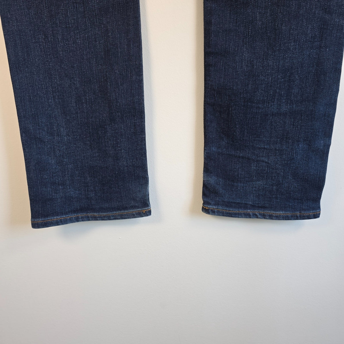 Superdry blue slim jeans with subtle fading, contrast orange stitching, and five-pocket design.