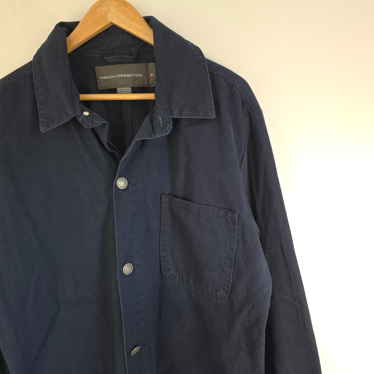 French Connection blue chore jacket with three patch pockets and metal button fastening.