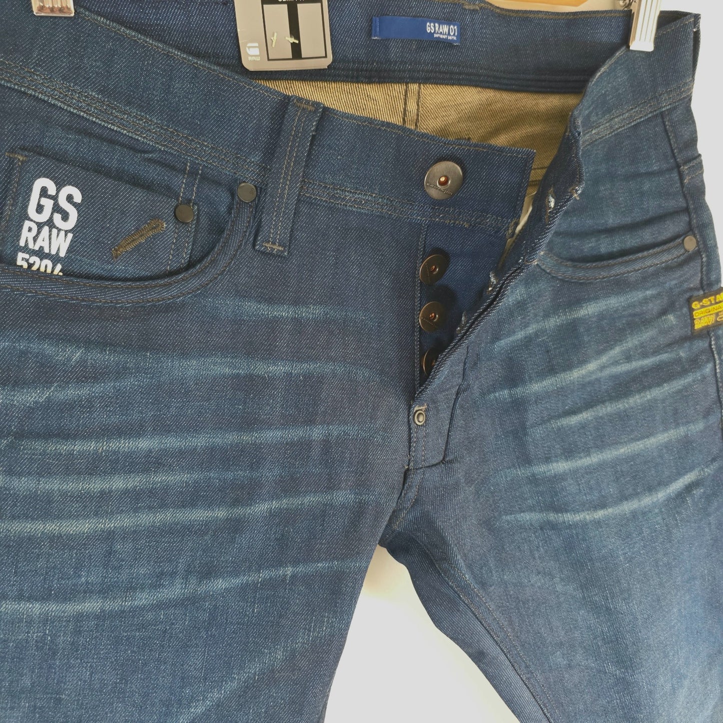 G-Star blue straight jeans with button fly and BNWT tag, cotton elastane blend.