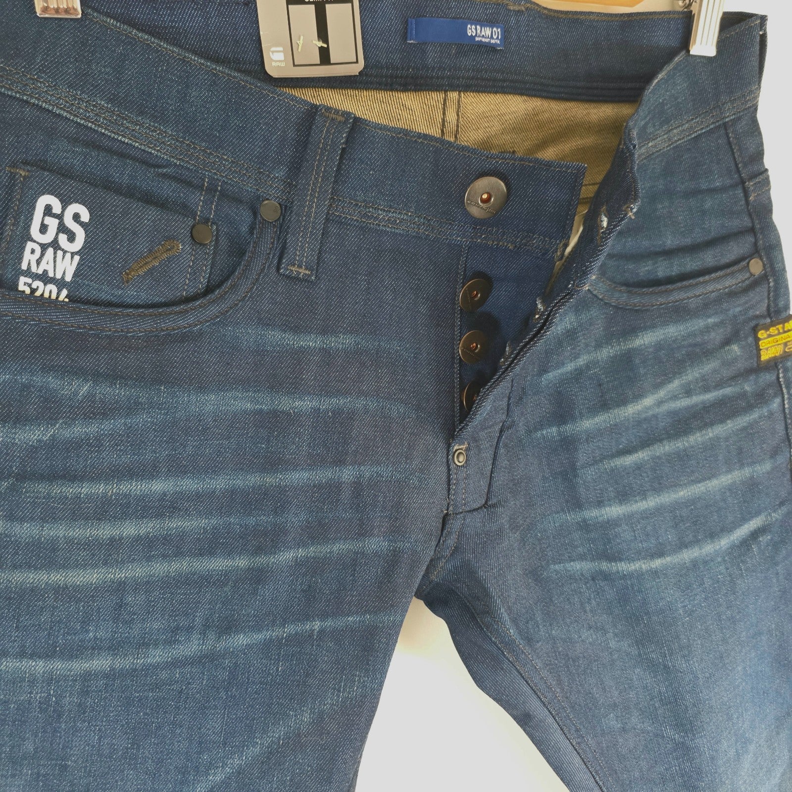 G-Star blue straight jeans with button fly and BNWT tag, cotton elastane blend.