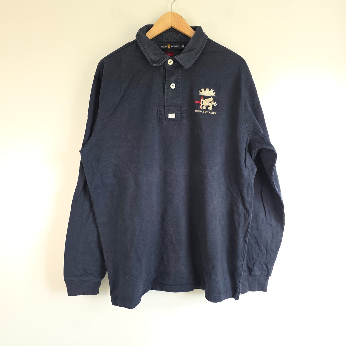 Marina Militare blue rugby shirt with embroidered crest and large nautical anchor appliqué.