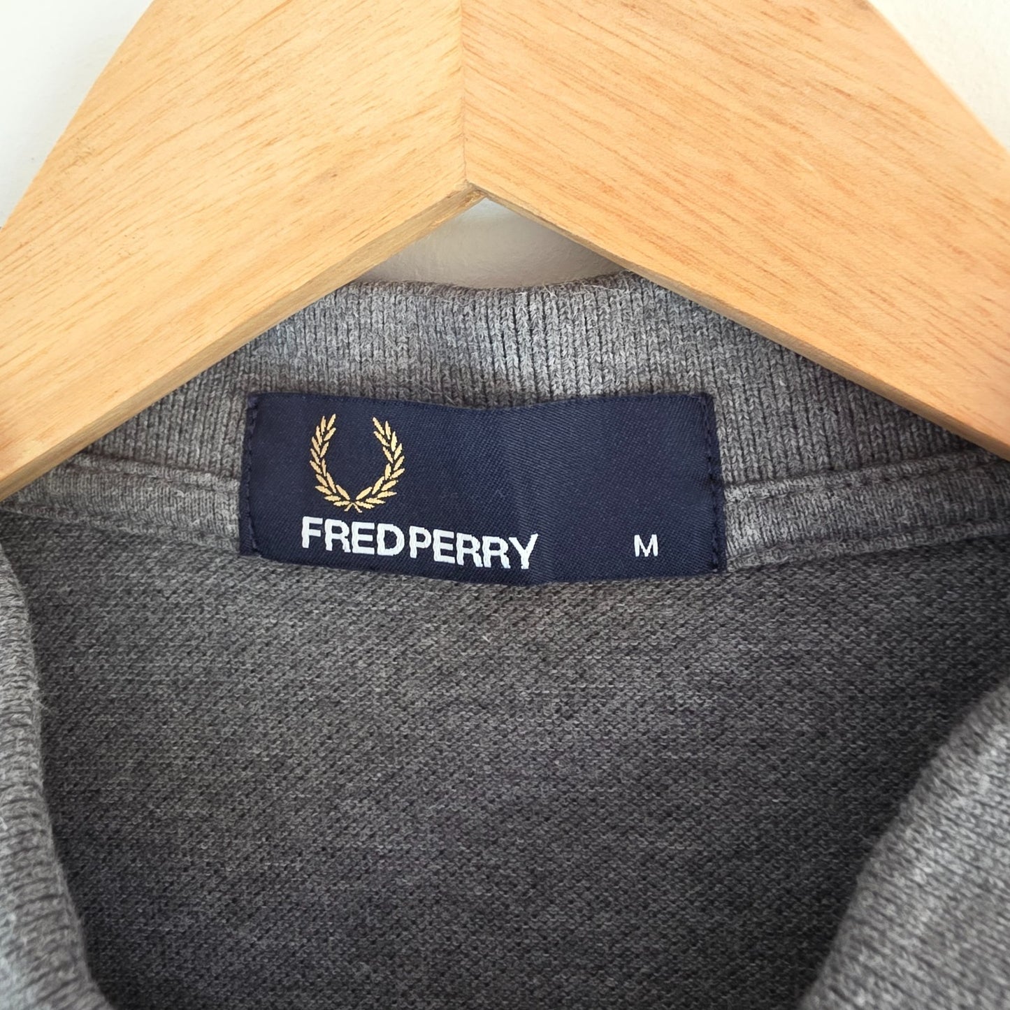 Fred Perry grey polo shirt with white twin tipping and classic laurel logo.