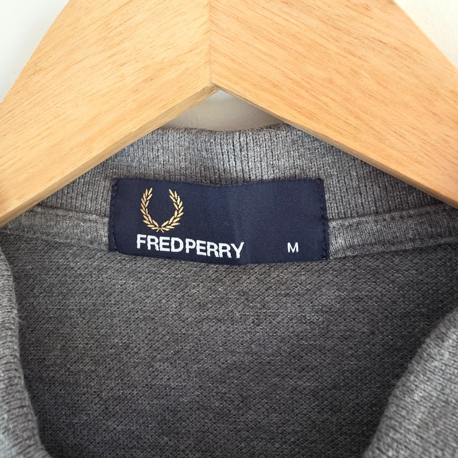 Fred Perry grey polo shirt with white twin tipping and classic laurel logo.