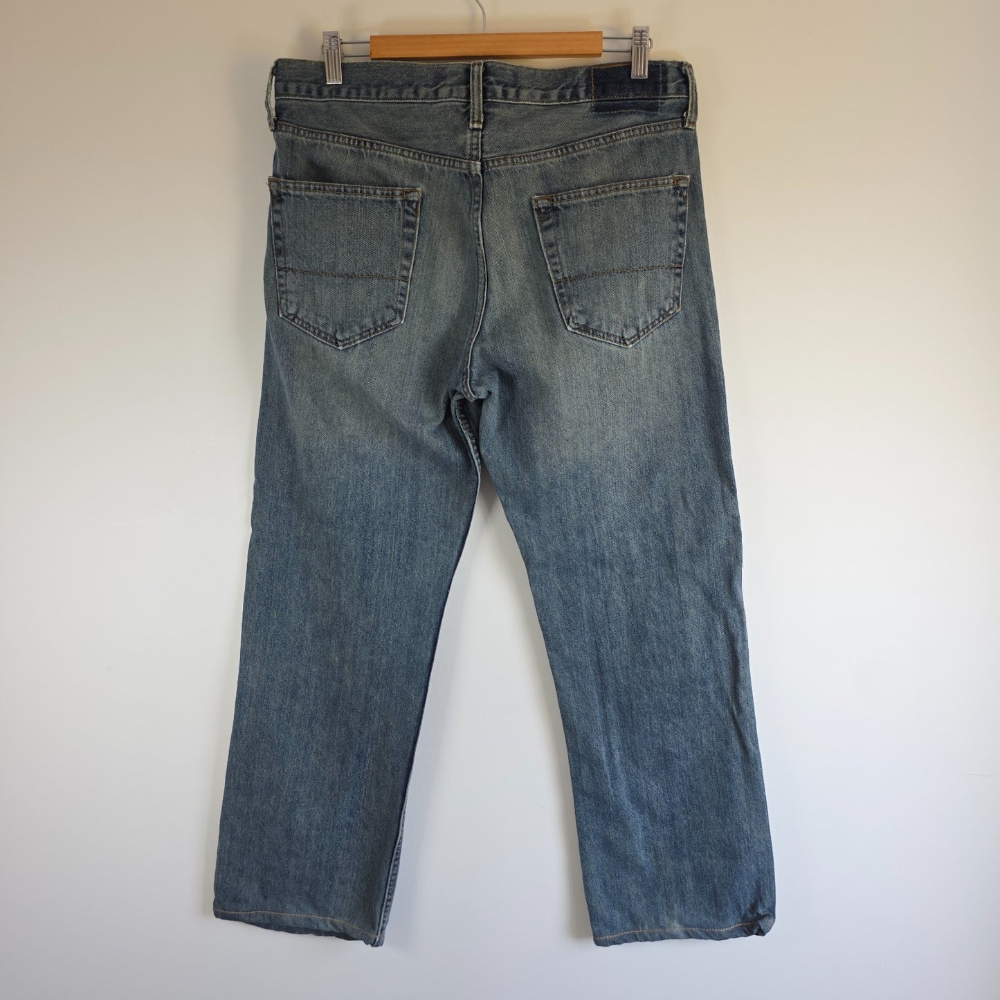 Levi's blue straight leg jeans, cotton material, missing back waist patch, casual style.